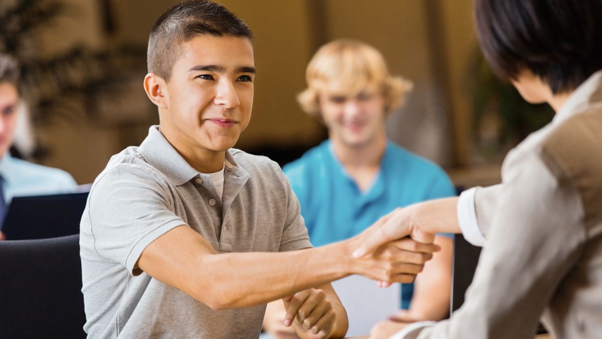 A student shaking hands at an interview