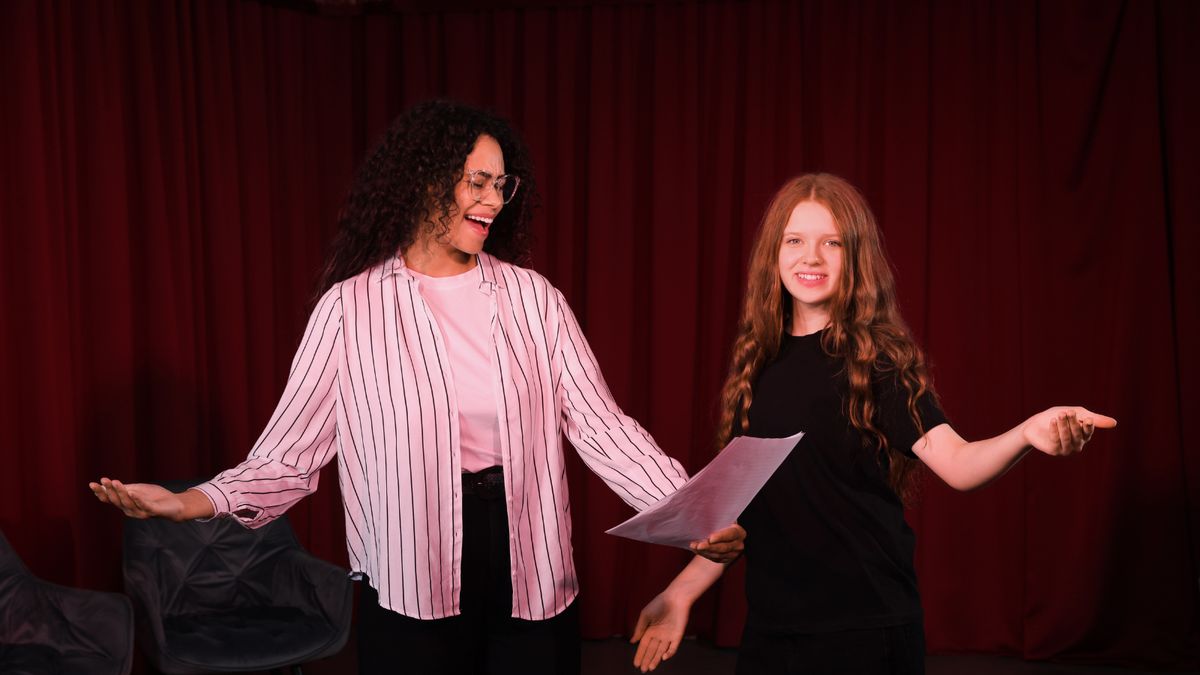 Two students performing a scene on stage