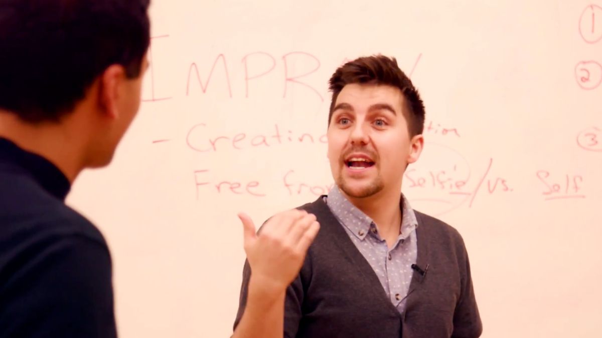 Tony Babcock teaching an improv class at a whiteboard